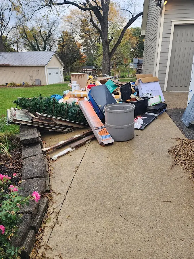 Dumpster being loaded with debris for Demolition Dumpster Rental in Griffin